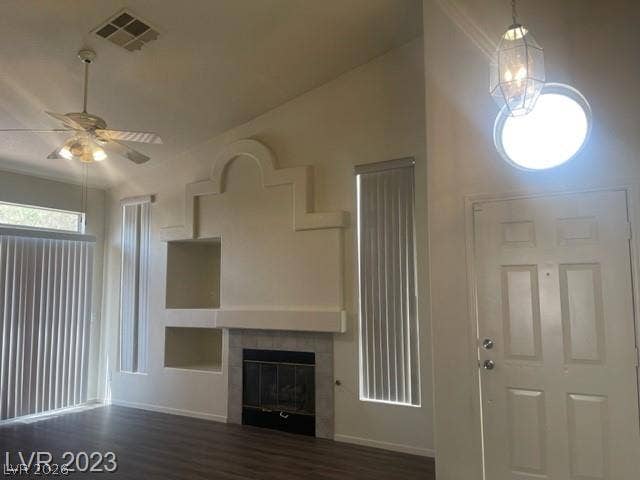 Soaring vaulted ceilings and a built-in fireplace mantle highlight this inviting entryway.
