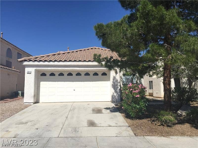 Classic tile roofing and stucco finishes accent the front exterior of this home.