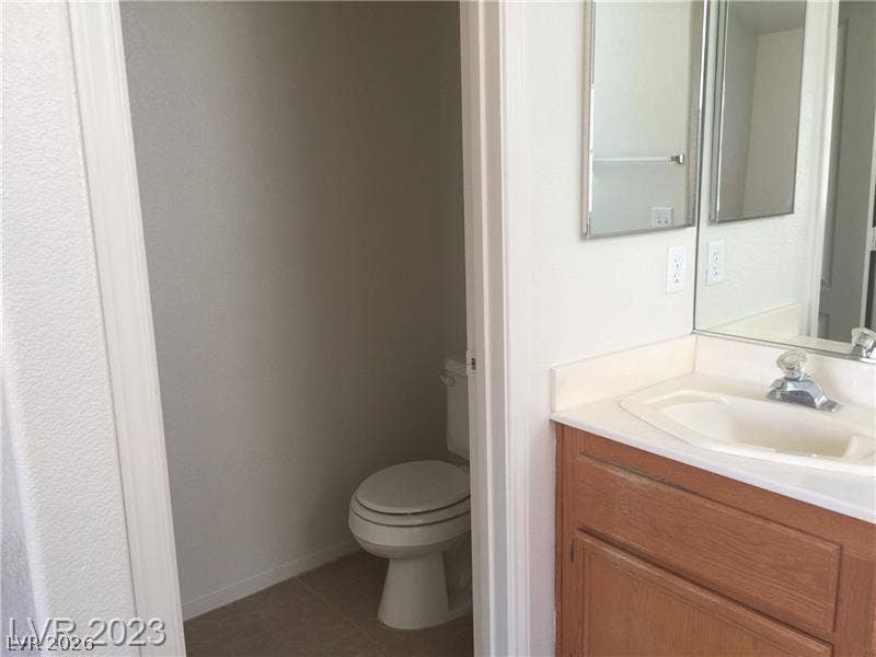 A functional bathroom layout connects a classic vanity area to a private toilet closet.