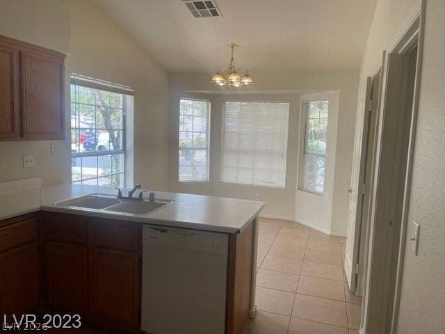 A spacious dining area features vaulted ceilings, tile flooring, and natural light from bay windows.
