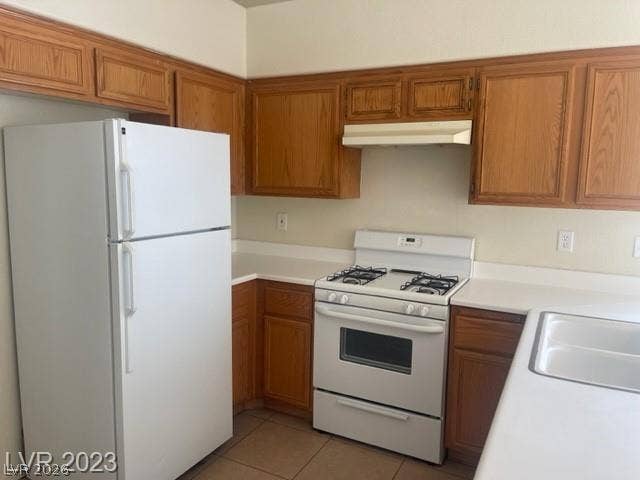 Ample wooden cabinetry and clean countertops define this functional cooking space.