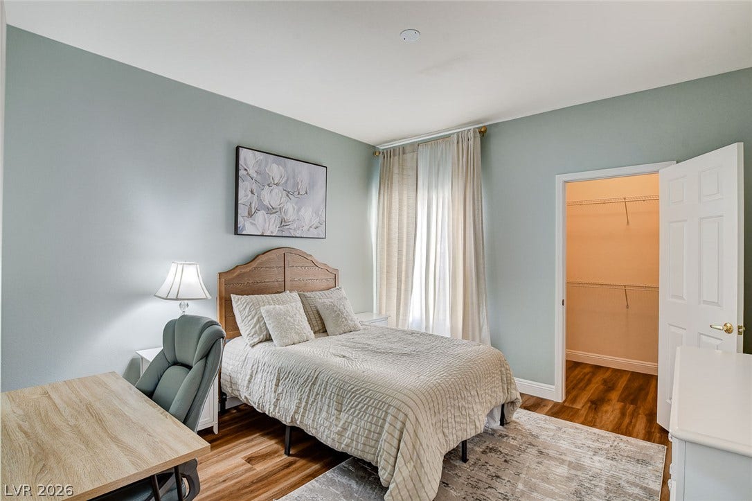 1520 Ruby Cliffs Lane, #203, Las Vegas, NV 89144 Rich wood-look flooring and smooth walls define this comfortable bedroom space.