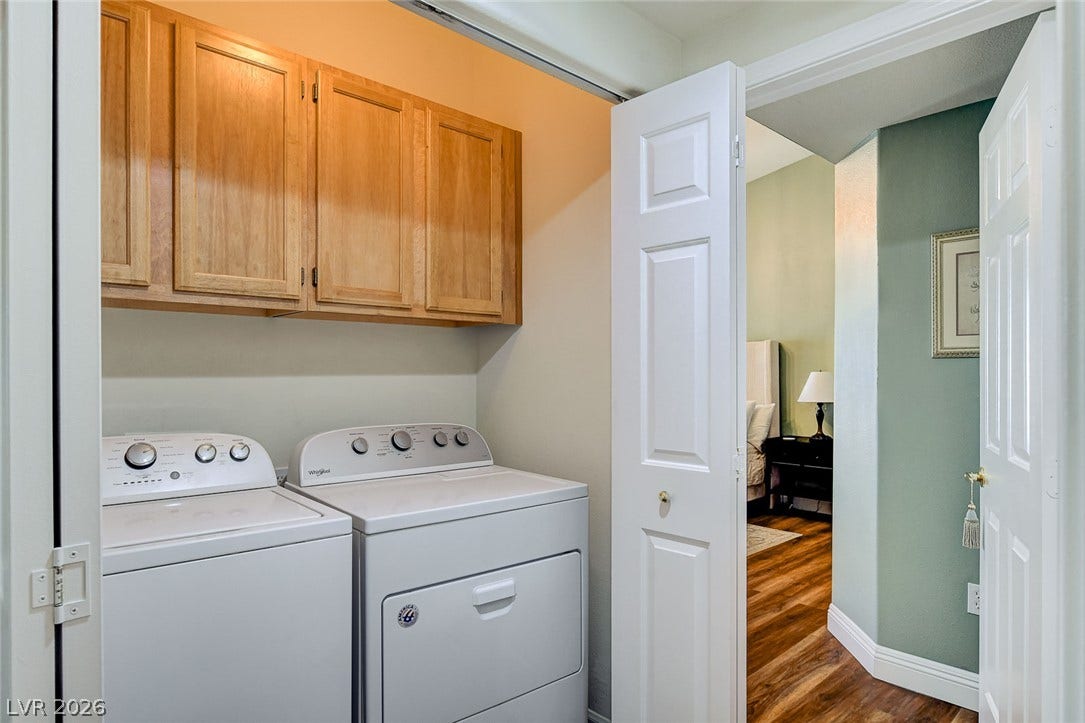 1520 Ruby Cliffs Lane, #203, Las Vegas, NV 89144 A dedicated laundry closet offers integrated upper cabinetry for convenient storage.
