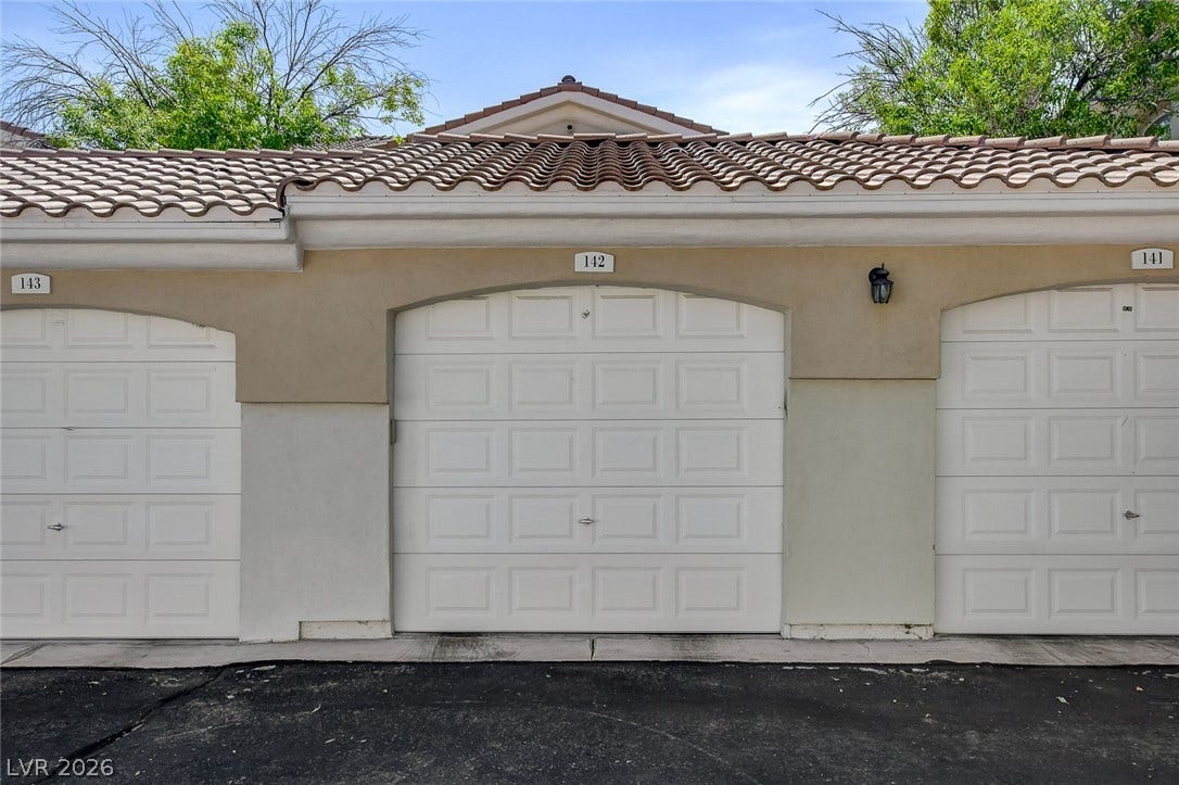 1520 Ruby Cliffs Lane, #203, Las Vegas, NV 89144 Stucco exterior finishes and tiled roofing crown these detached garage structures.