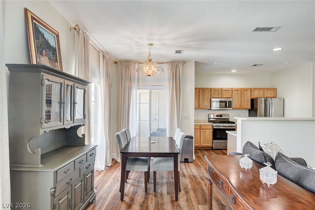 1520 Ruby Cliffs Lane, #203, Las Vegas, NV 89144 Gleaming wood floors connect a bright dining area directly to the adjoining kitchen.