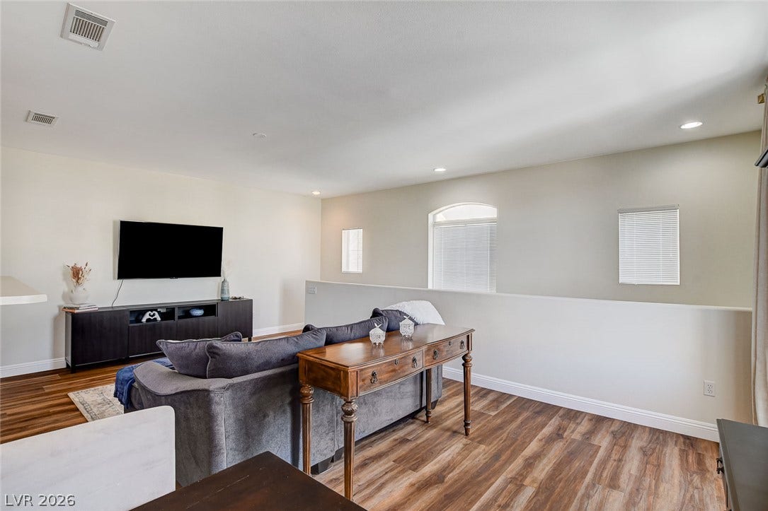 1520 Ruby Cliffs Lane, #203, Las Vegas, NV 89144 Gleaming hardwood floors and recessed lighting enhance this upper-level living area.