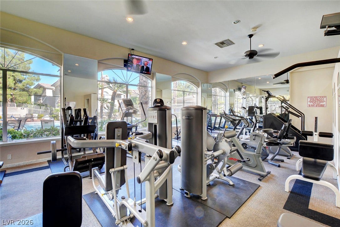 1520 Ruby Cliffs Lane, #203, Las Vegas, NV 89144 Large arched windows flood the well-equipped fitness space with natural light.