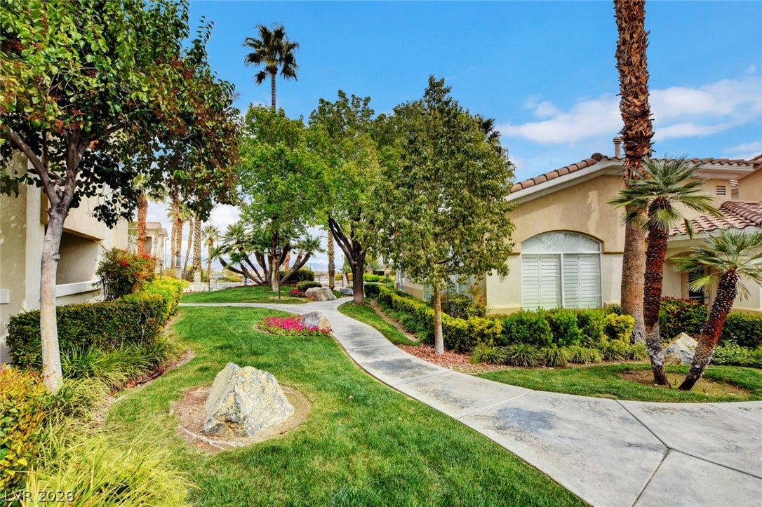 1520 Ruby Cliffs Lane, #203, Las Vegas, NV 89144 Lush manicured green space and paved walkways wind past elegant tile-roof residences.