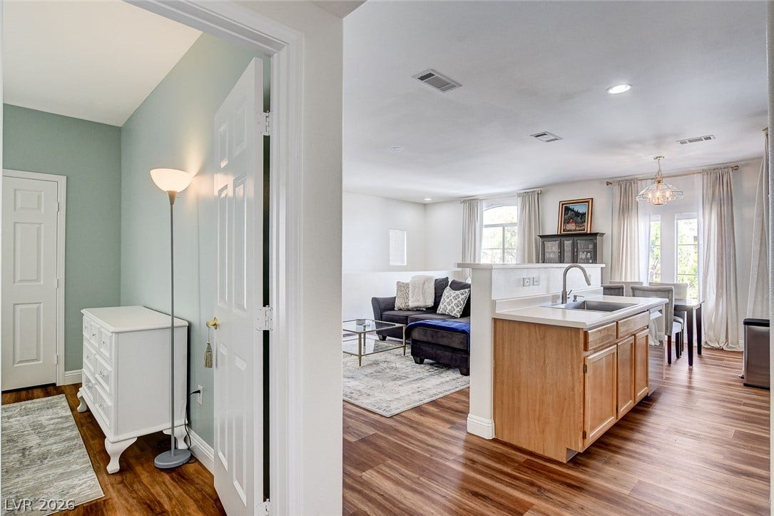 1520 Ruby Cliffs Lane, #203, Las Vegas, NV 89144 An inviting open floorplan seamlessly connects the entryway, kitchen area, and living spaces.