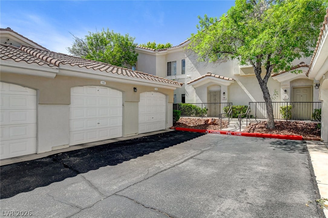 1520 Ruby Cliffs Lane, #203, Las Vegas, NV 89144 Stucco exterior finishes and Spanish tile roofing establish classic architectural charm.