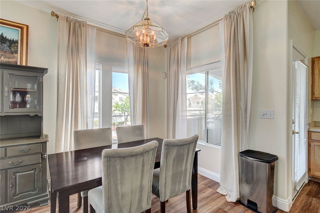 1520 Ruby Cliffs Lane, #203, Las Vegas, NV 89144 Elegant crown molding complements high ceilings and rich wood flooring in this refined dining area.