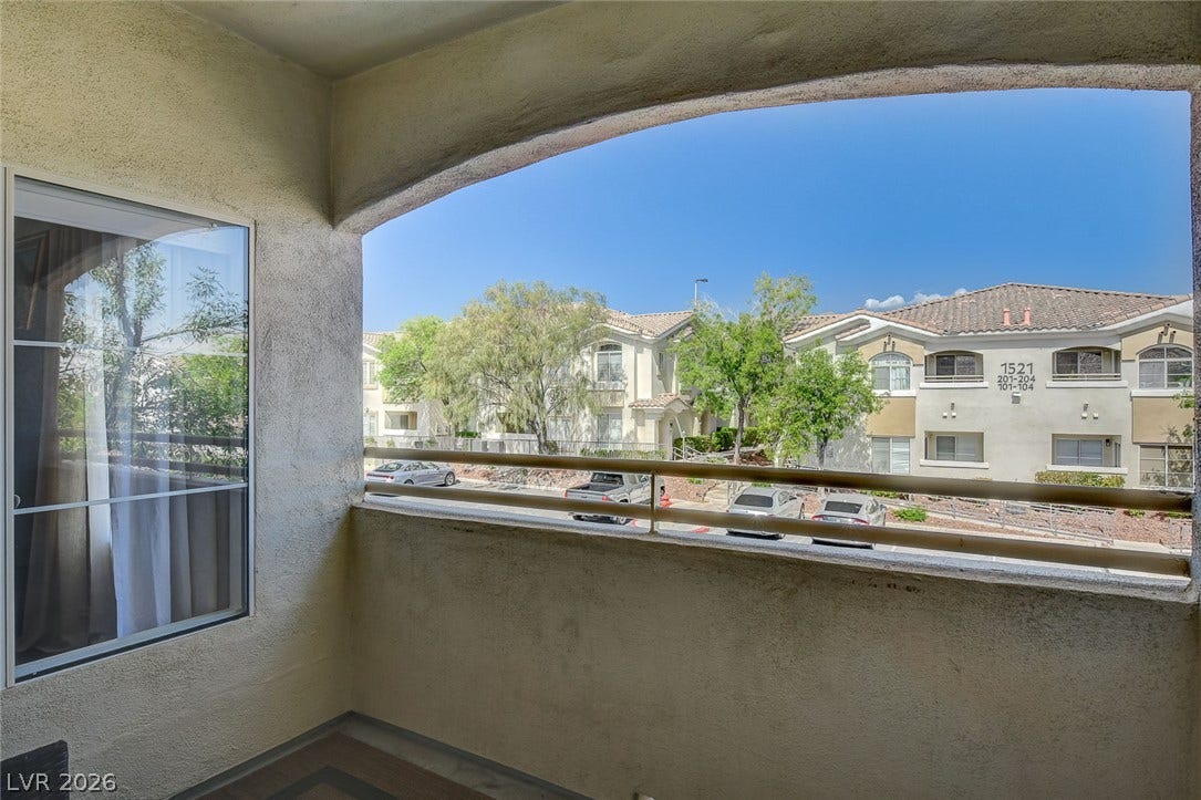 1520 Ruby Cliffs Lane, #203, Las Vegas, NV 89144 Stucco arches frame views of the surrounding neighborhood from this private elevated outdoor space.