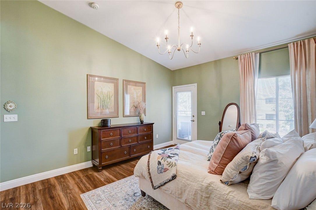 1520 Ruby Cliffs Lane, #203, Las Vegas, NV 89144 High ceilings and warm wood floors define this tranquil main suite with outdoor access.