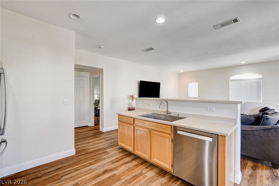1520 Ruby Cliffs Lane, #203, Las Vegas, NV 89144 Warm wood flooring and recessed lighting define this inviting open kitchen layout.