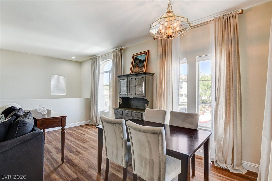 1520 Ruby Cliffs Lane, #203, Las Vegas, NV 89144 Rich wood flooring runs through this dining area detailed with classic crown molding.