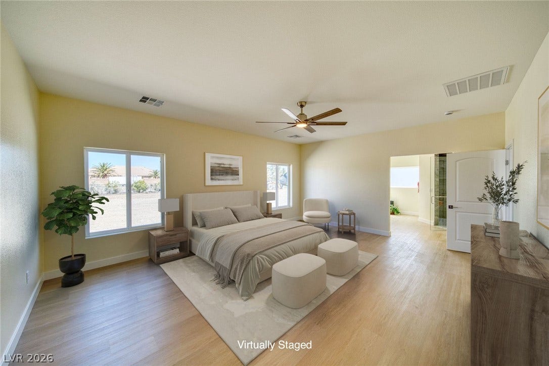 2880 S Red Rock, Pahrump, NV 89048 Virtually staged primary bedroom with vaulted ceilings and beautiful flooring.