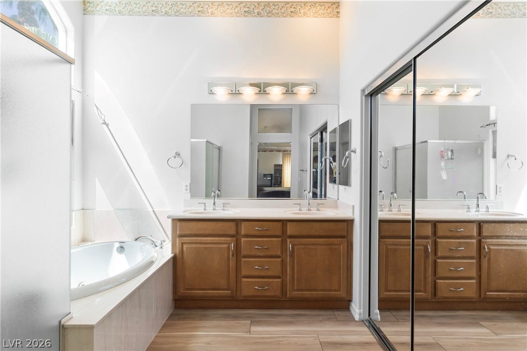 Double vanities and a relaxing soaking tub create a luxurious primary bathroom oasis.