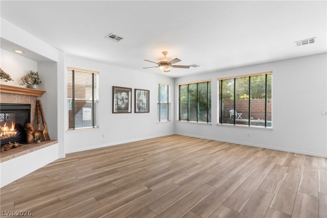A welcoming living area boasts durable wood-look flooring and a cozy fireplace, perfect for relaxation.
