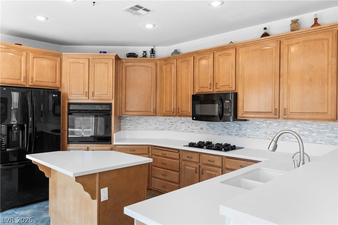 A well-appointed kitchen offers ample cabinetry, modern appliances, and generous counter space for culinary endeavors.