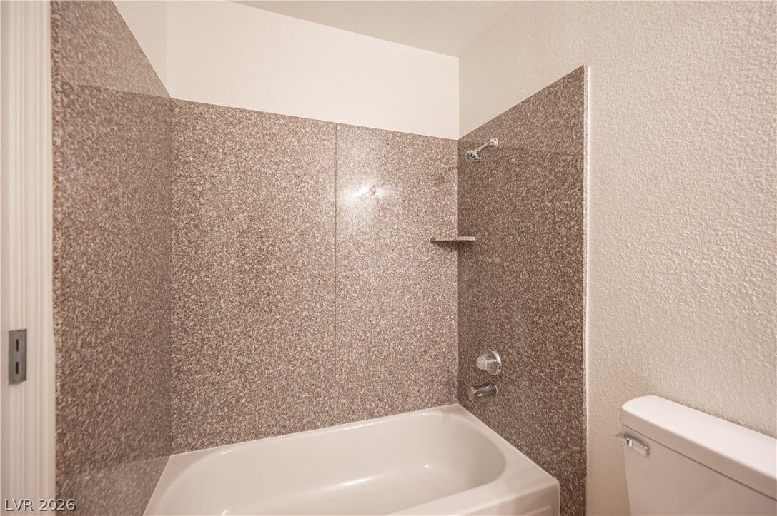 4381 Alexis Drive, #332, Las Vegas, NV 89103 Polished stone surrounds enclose a classic bathtub shower combination.
