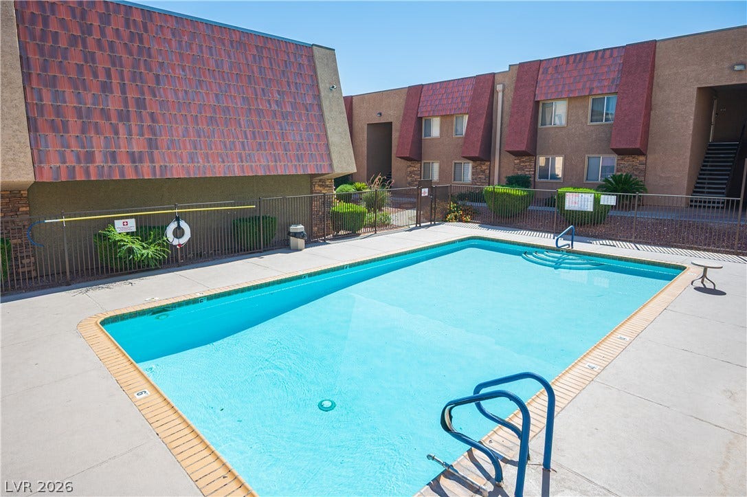 4381 Alexis Drive, #332, Las Vegas, NV 89103 A sparkling blue swimming pool offers a refreshing escape surrounded by concrete decking.
