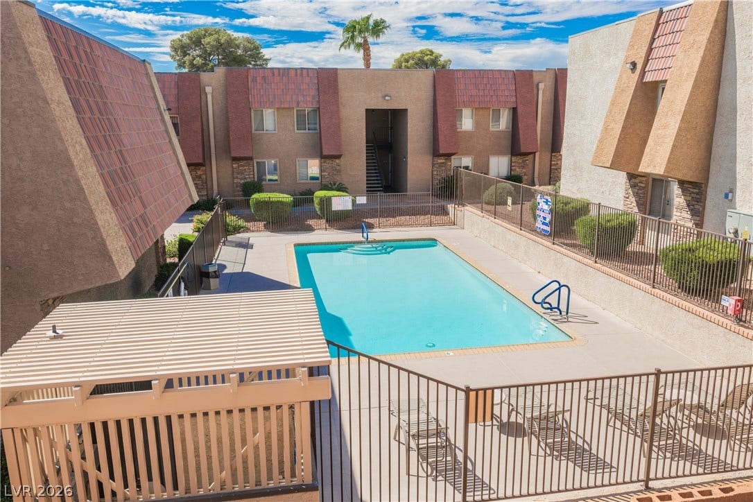 4381 Alexis Drive, #332, Las Vegas, NV 89103 A fenced community pool offers a refreshing outdoor space surrounded by multi-story residential buildings.