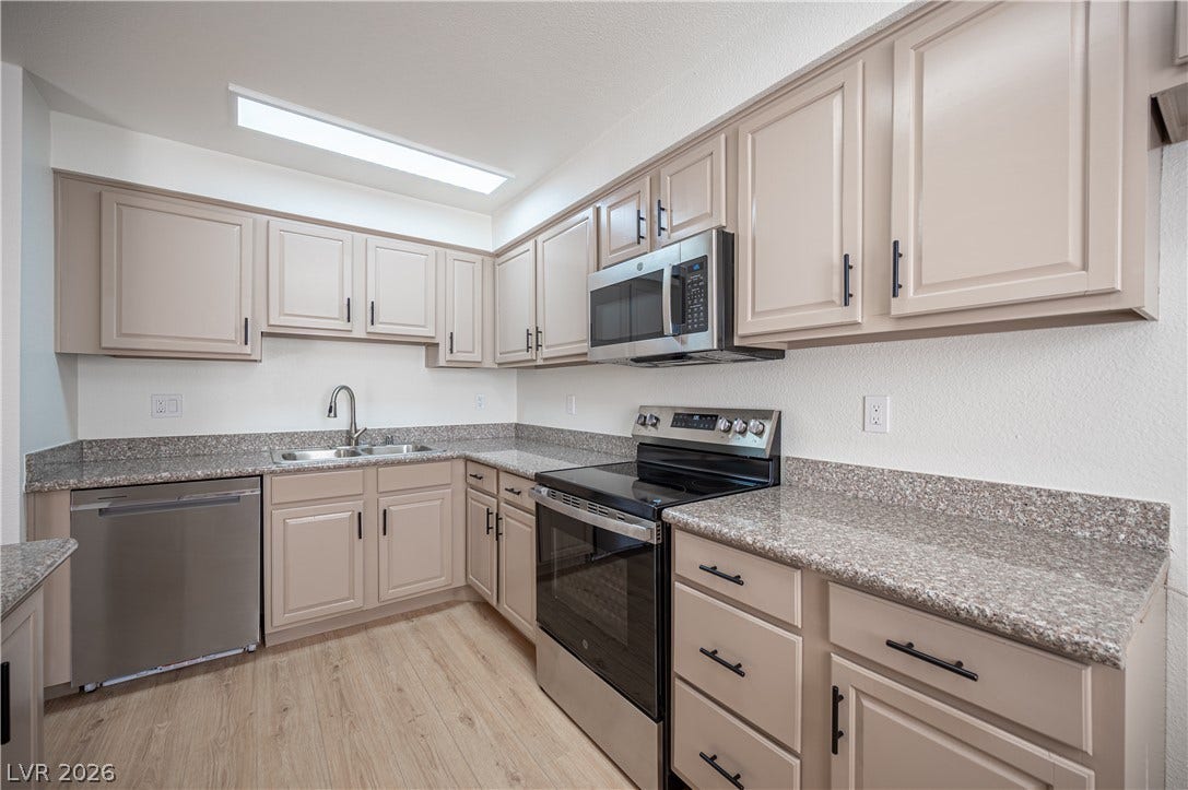 4381 Alexis Drive, #332, Las Vegas, NV 89103 Durable stone countertops pair with classic cabinetry in this well-appointed culinary space.