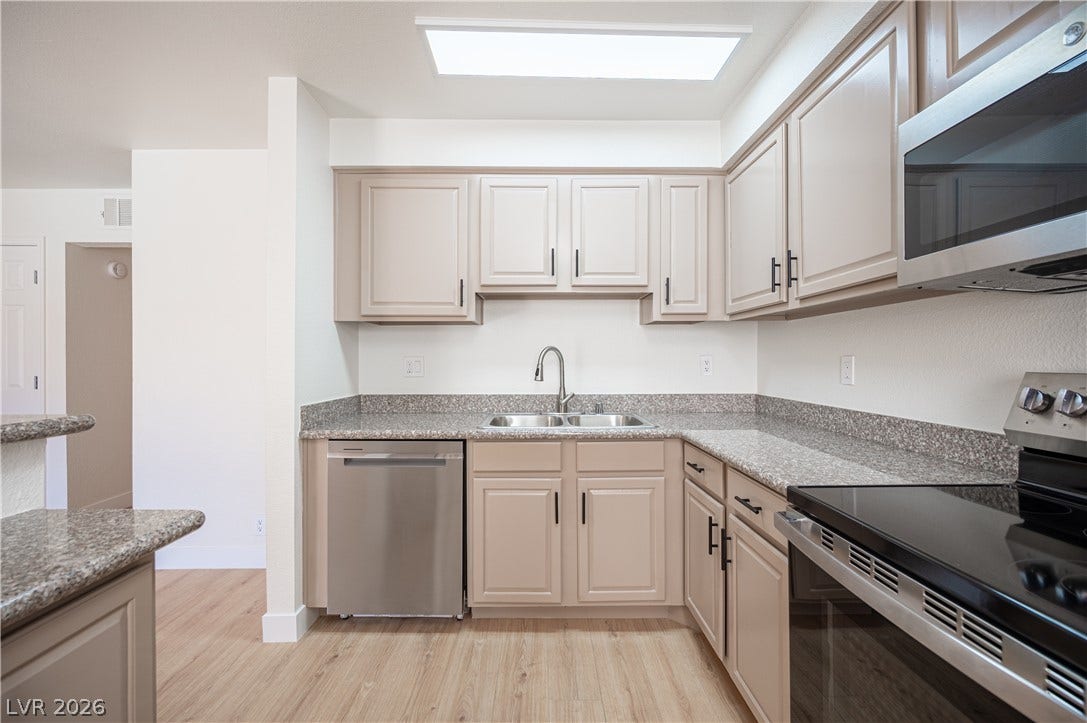 4381 Alexis Drive, #332, Las Vegas, NV 89103 Polished stone countertops pair with clean cabinetry in a bright cooking space.
