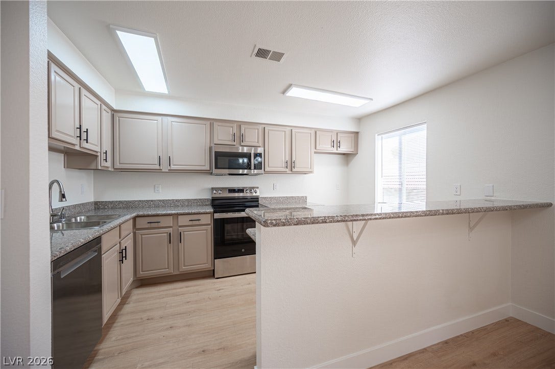 4381 Alexis Drive, #332, Las Vegas, NV 89103 Ample counter space and functional cabinetry define this classic kitchen layout.
