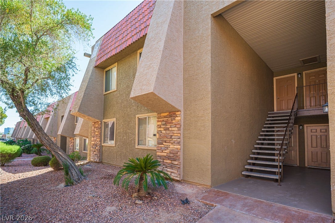 4381 Alexis Drive, #332, Las Vegas, NV 89103 Distinctive architectural angles and stone accents define this inviting multi-level residential exterior.