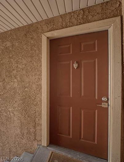 4381 Alexis Drive, #332, Las Vegas, NV 89103 A welcoming front entry features textured stucco siding and a paneled entry door.