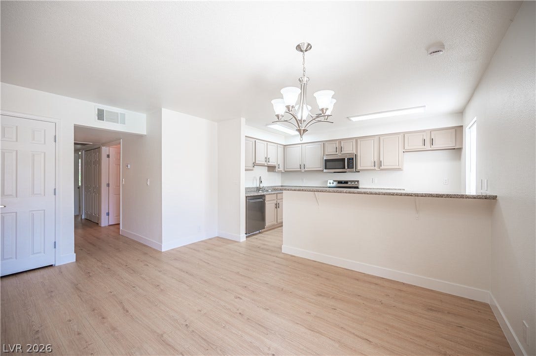 4381 Alexis Drive, #332, Las Vegas, NV 89103 An open floorplan seamlessly connects the airy living area to the fully equipped kitchen.