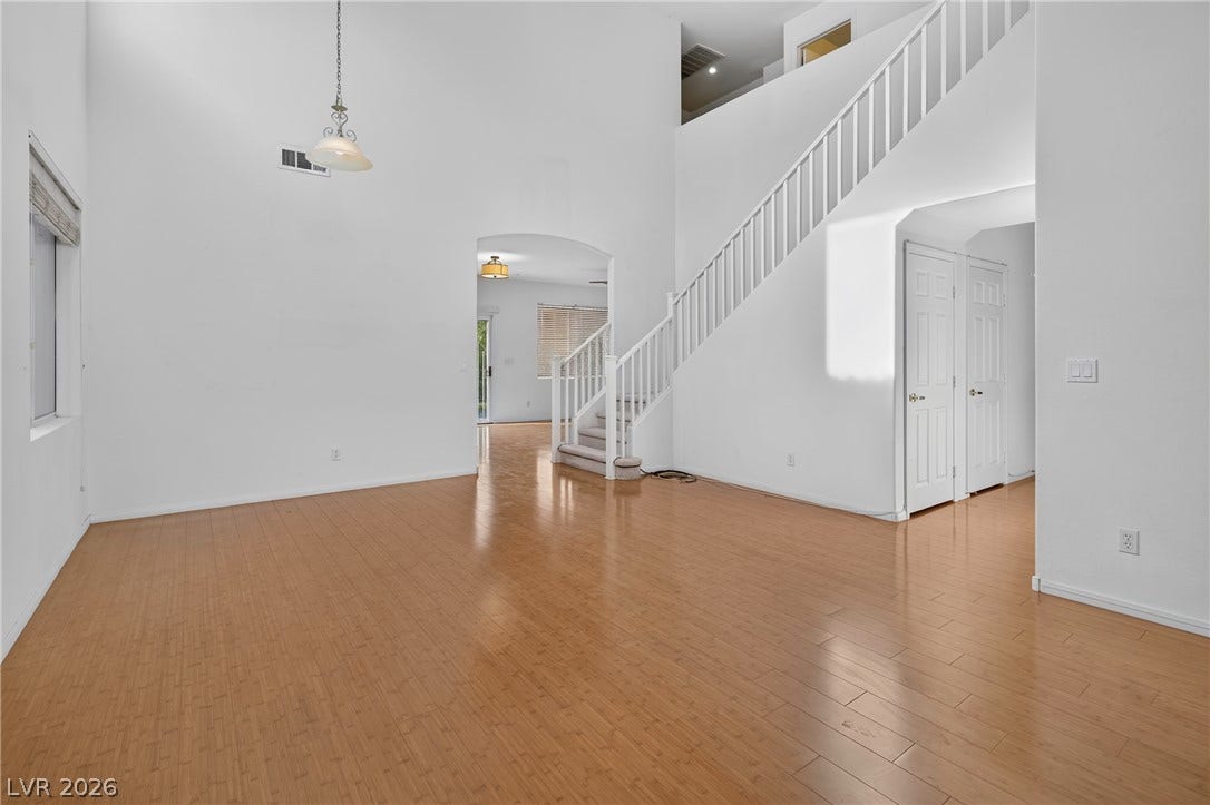 4871 Lionesse Court, Las Vegas, NV 89130 Gleaming hardwood floors and a soaring two-story ceiling define this airy living space.