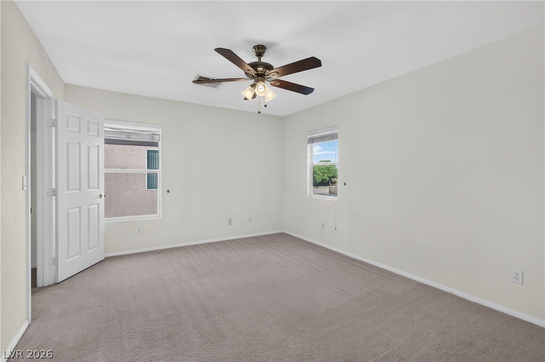 4871 Lionesse Court, Las Vegas, NV 89130 Plush carpeting and dual windows bring a welcoming warmth to this comfortable bedroom.