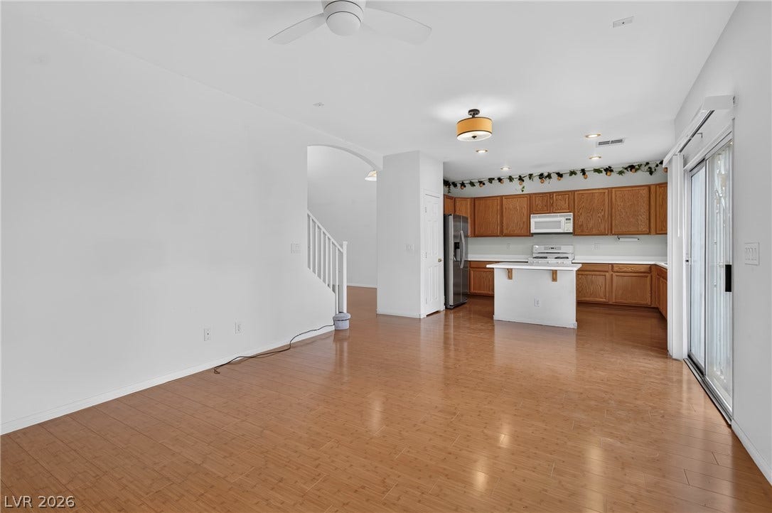 4871 Lionesse Court, Las Vegas, NV 89130 Gleaming hardwood floors and a sliding glass door define this airy, open-concept layout.