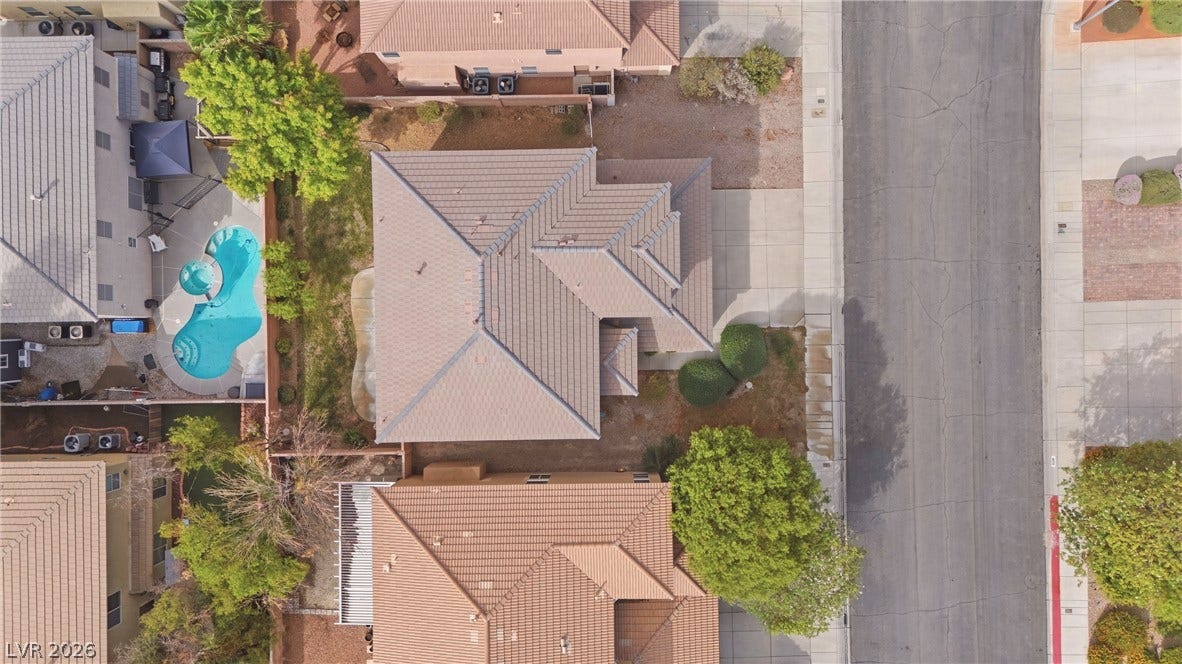4871 Lionesse Court, Las Vegas, NV 89130 An aerial perspective showcases the tiled roofline and structured layout of this suburban property.
