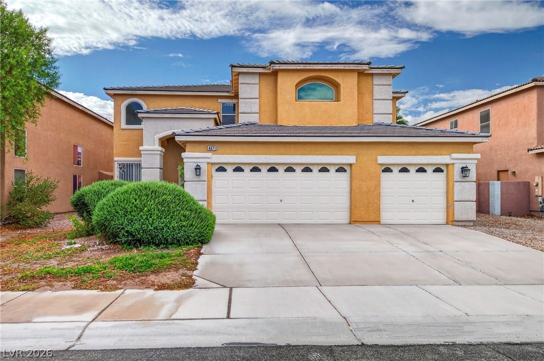 4871 Lionesse Court, Las Vegas, NV 89130 Stucco exterior and arched windows create classic architectural appeal on a quiet neighborhood street.