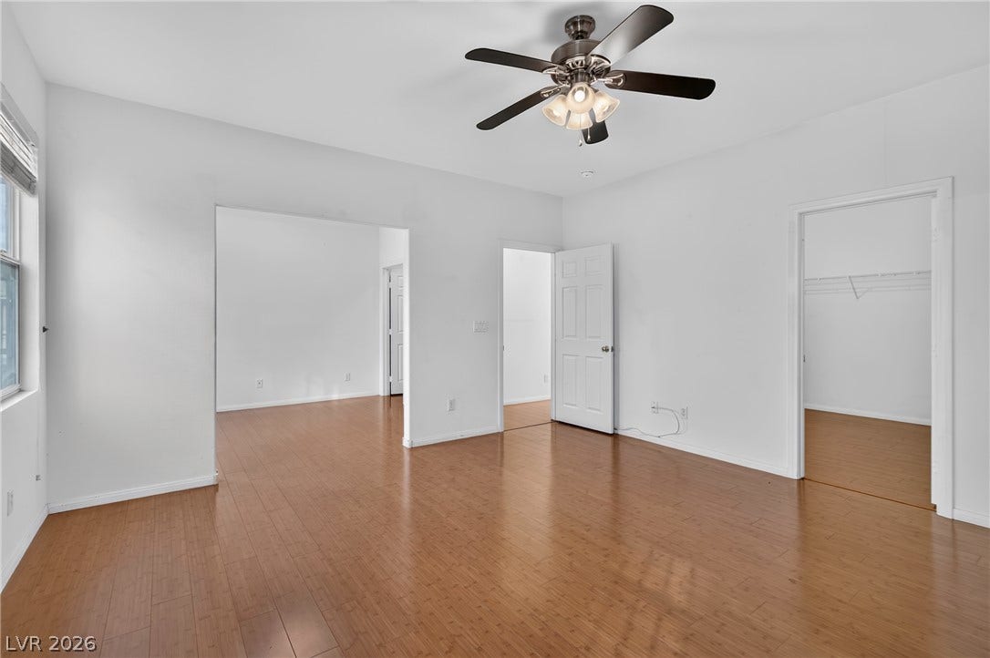 4871 Lionesse Court, Las Vegas, NV 89130 Polished wood floors anchor this versatile room designed with wide openings to adjacent spaces.