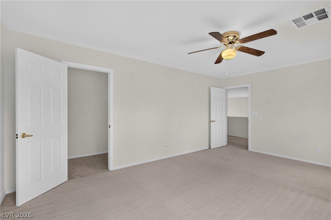 4871 Lionesse Court, Las Vegas, NV 89130 Soft carpeting spans this versatile bedroom space featuring neutral walls.