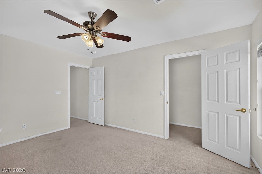 4871 Lionesse Court, Las Vegas, NV 89130 Plush neutral carpeting and classic white trim define this versatile secondary bedroom space.