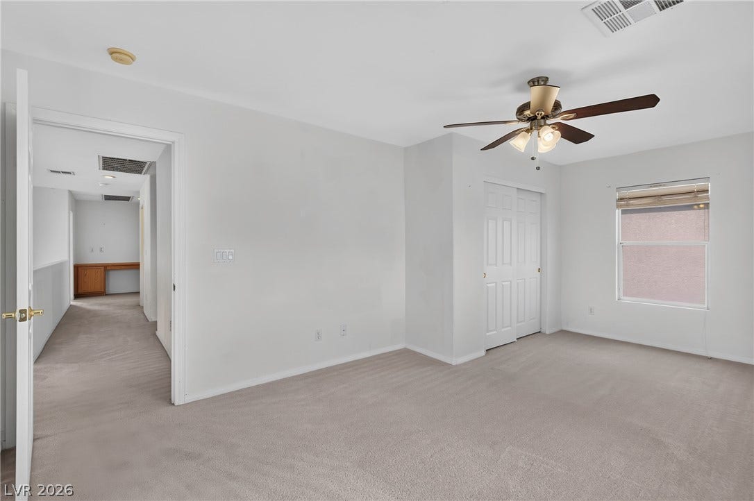 4871 Lionesse Court, Las Vegas, NV 89130 Soft carpeting pairs with neutral walls in this comfortable bedroom space.