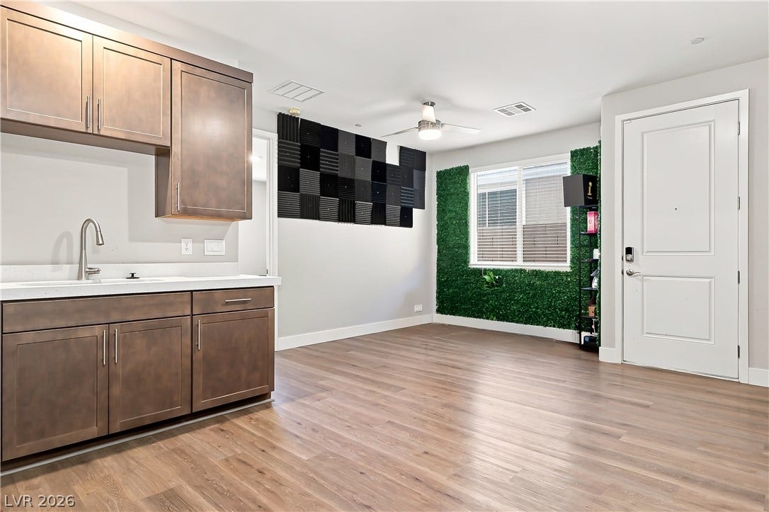 Multigenerational downstairs suite kitchenette with dining area and separate entrance.