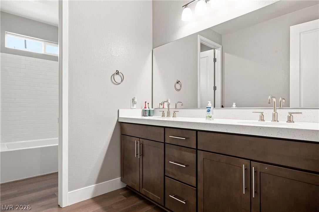 Clean lines and a spacious dual vanity highlight this contemporary bathroom space.