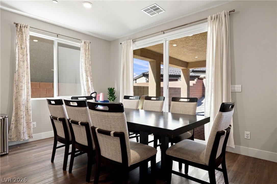 Sliding glass doors open from the dining space directly to a covered outdoor patio.