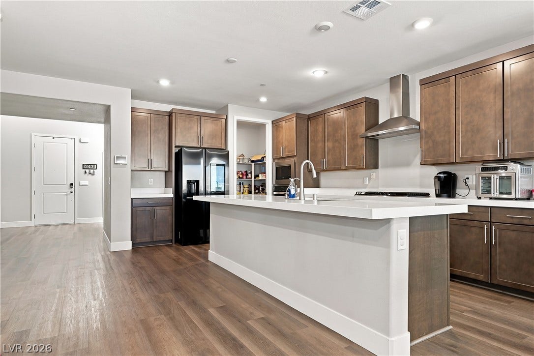Warm wood cabinetry and durable flooring define this modern kitchen with a central island.