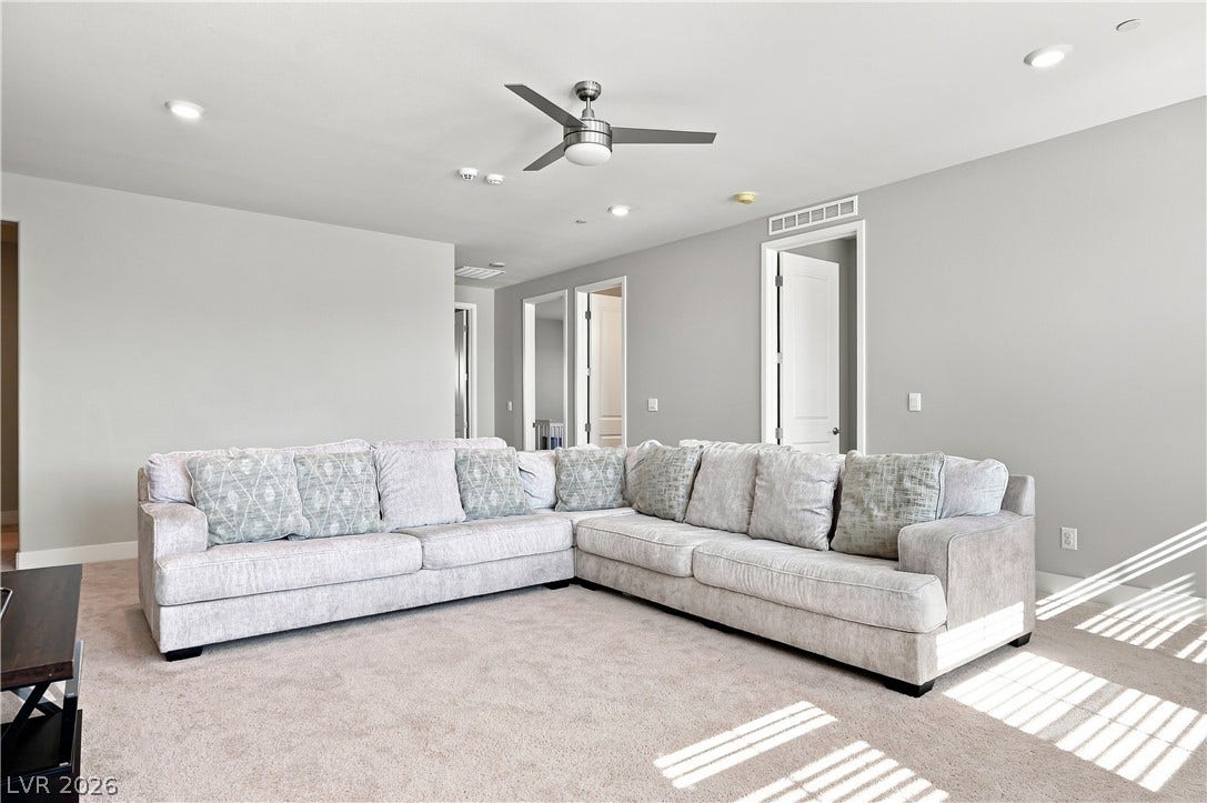 Plush wall-to-wall carpeting and recessed lighting create a comfortable second-story living area.