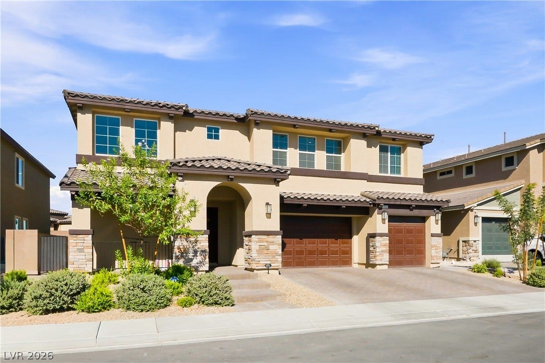 Stone accents and arched entryways highlight this beautiful contemporary exterior design.