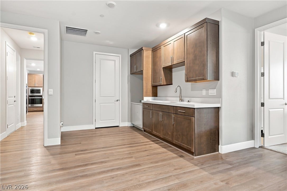 Downstairs Multigenerational suite featuring a kitchenette, dining area, private bathroom, and separate entrance.