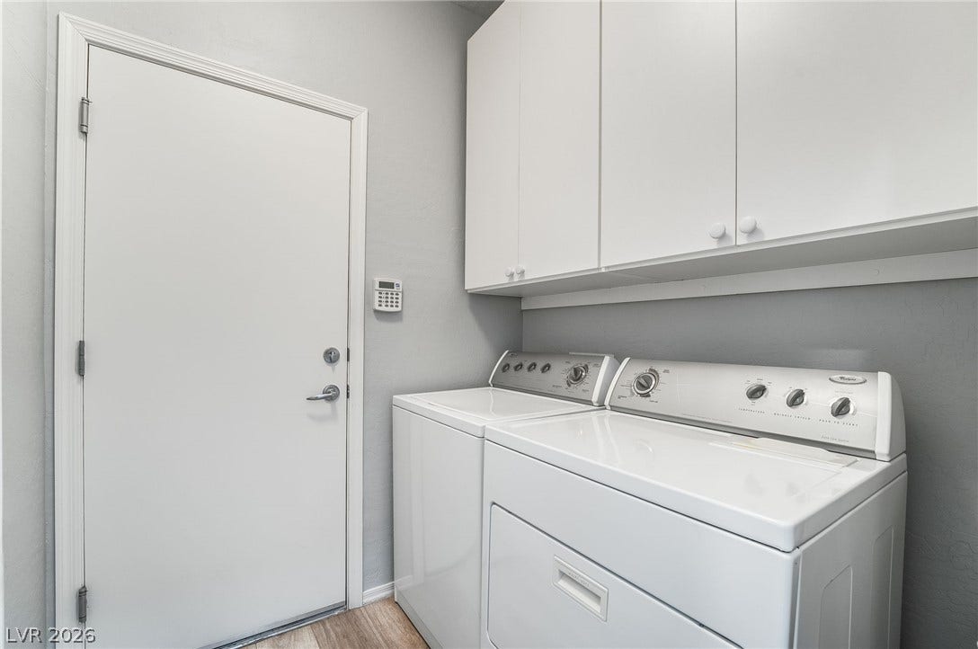 Washer and dryer included with cabinets offering additional storage