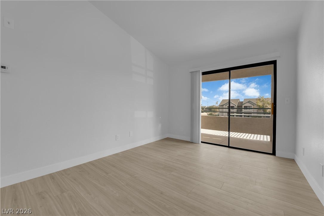 5111 Lindell Road, #202, Las Vegas, NV 89118 Sliding glass doors open directly to a private balcony from this light-filled room.